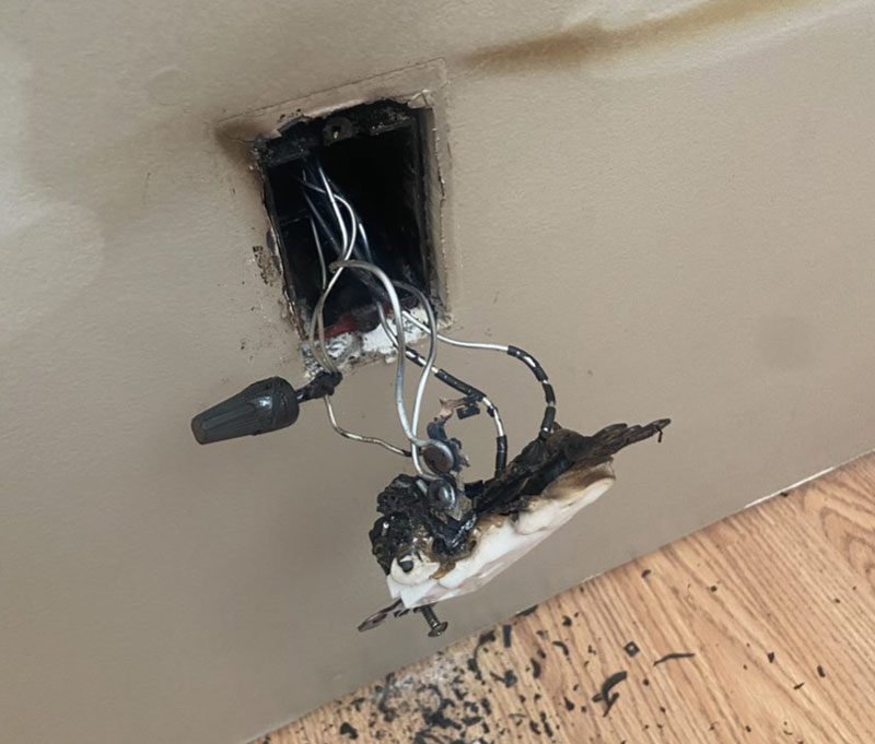 An Electrician Repairing the AC Power Plugs and Sockets